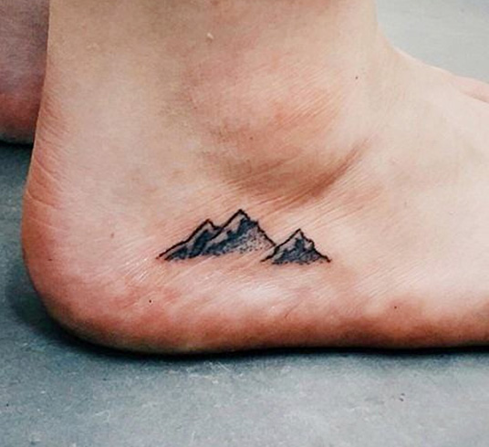 Mountain tattoo on foot for girls
