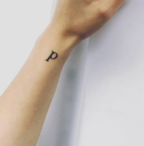 Single letter tattoo on wrist